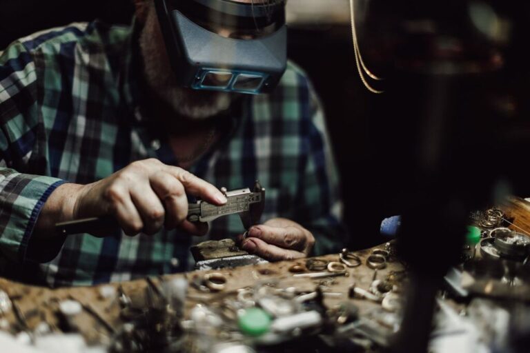 a jeweler working on jewelry on his workbench