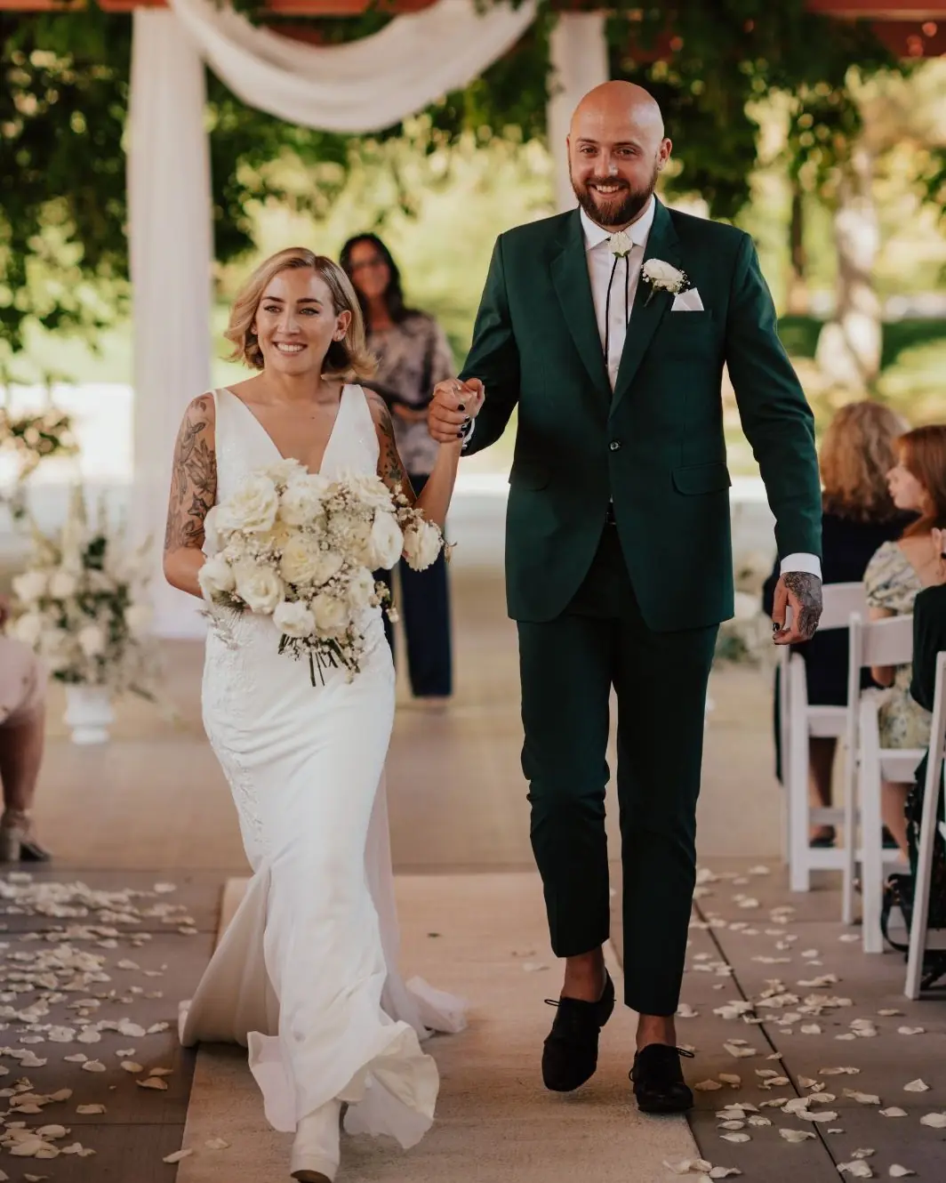 A newlywed couple walking hand in hand after their wedding ceremony