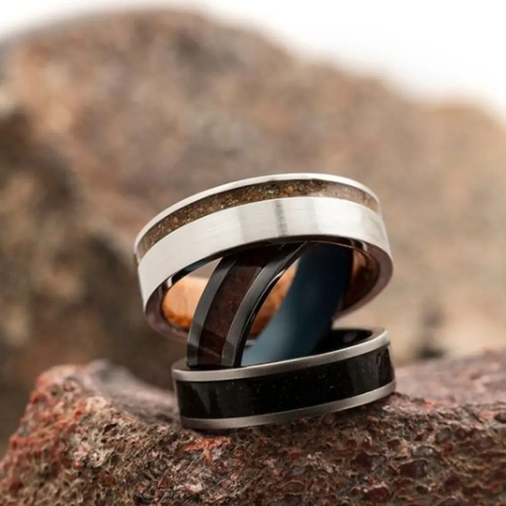 Three mens ring displayed on a rock