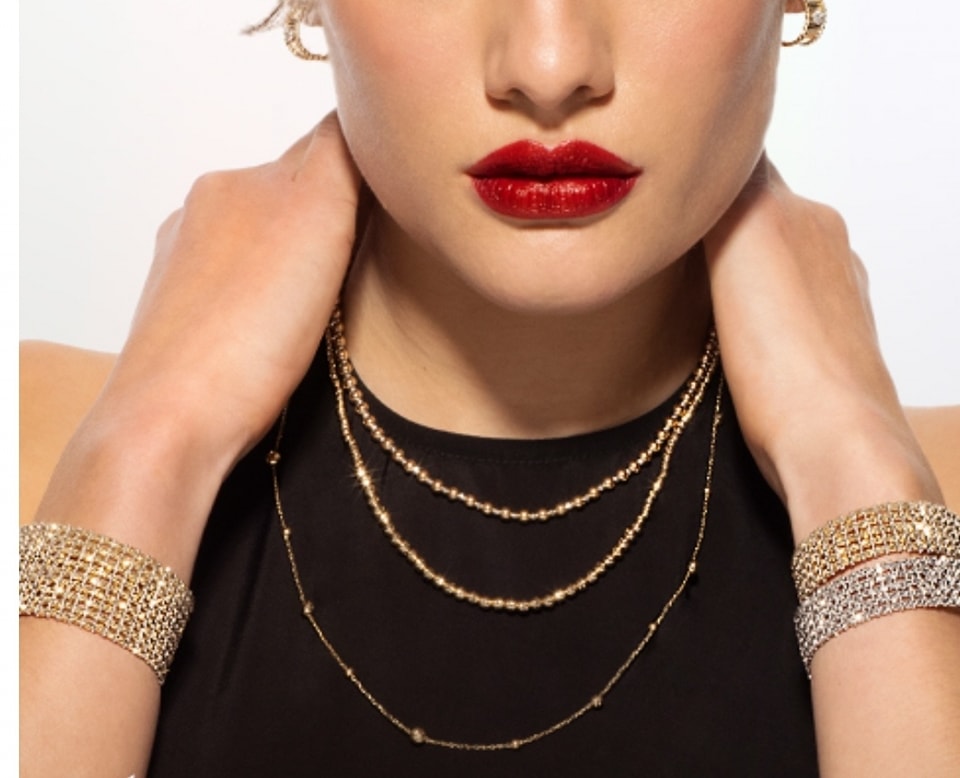 A women wearing gold necklaces and bracelets
