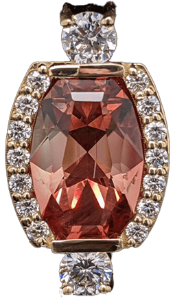 A Red Gem Pendent with diamonds around the frond